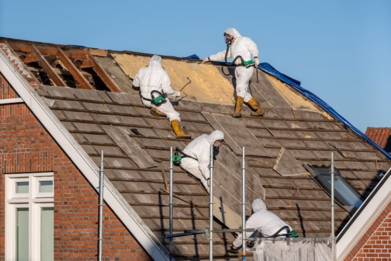 Professionals in suits remove asbestos cement roofing material